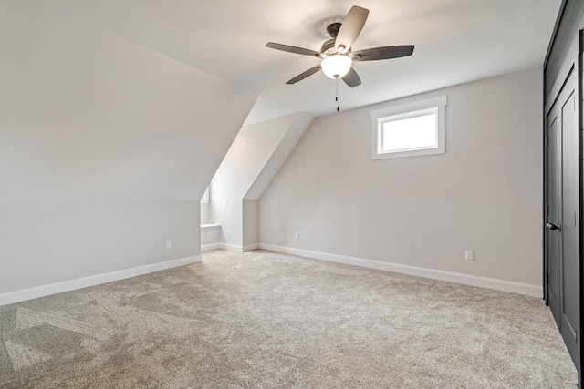 bonus room featuring carpet flooring, ceiling fan, lofted ceiling, and baseboards