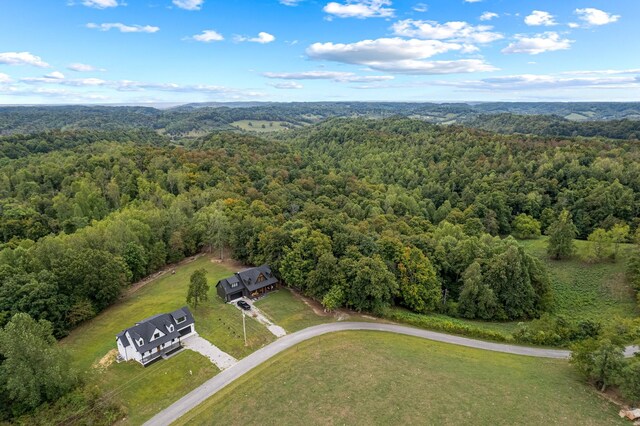aerial view featuring a wooded view