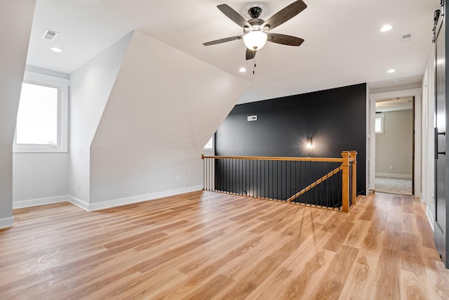 bonus room with light wood finished floors, visible vents, ceiling fan, and baseboards