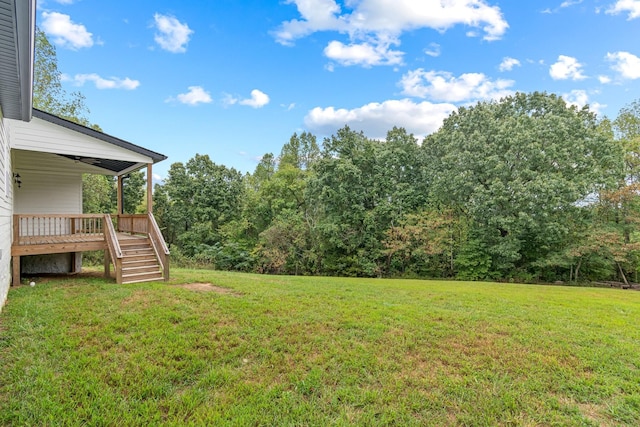view of yard with stairs and a wooden deck