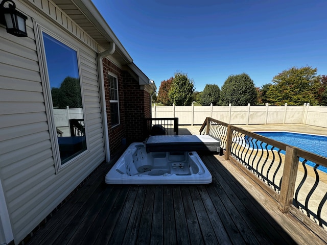 deck featuring a fenced in pool