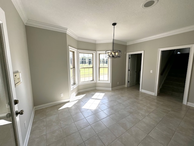 unfurnished dining area with an inviting chandelier, ornamental molding, a textured ceiling, and light tile patterned floors