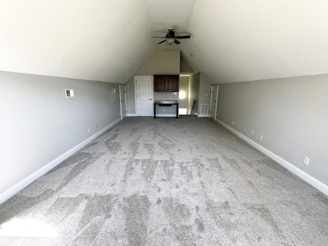 bonus room featuring vaulted ceiling, light colored carpet, and ceiling fan