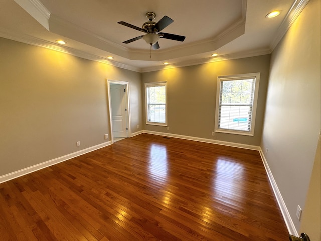 unfurnished room featuring crown molding, a healthy amount of sunlight, and dark wood-type flooring