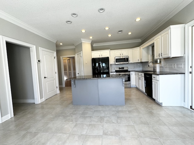 kitchen with ornamental molding, black appliances, a kitchen island, and tasteful backsplash