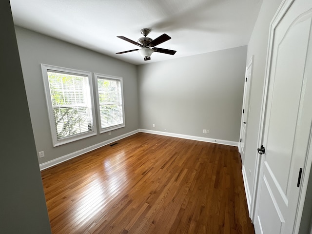 unfurnished bedroom with dark hardwood / wood-style flooring and ceiling fan