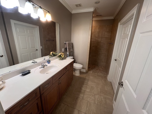 bathroom with ornamental molding, tiled shower, vanity, and toilet