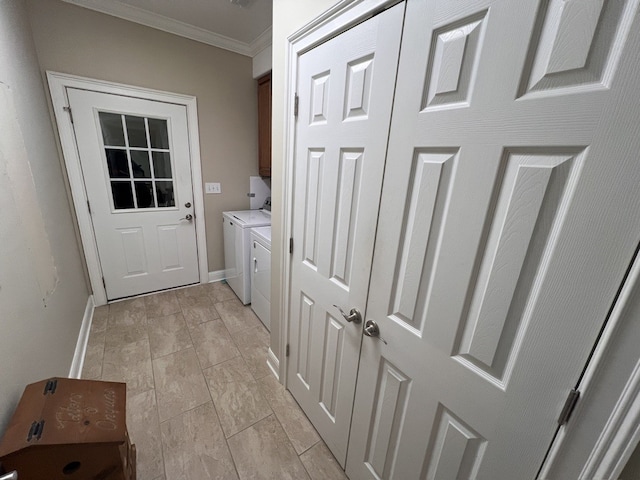 laundry area featuring cabinets, crown molding, and washing machine and dryer