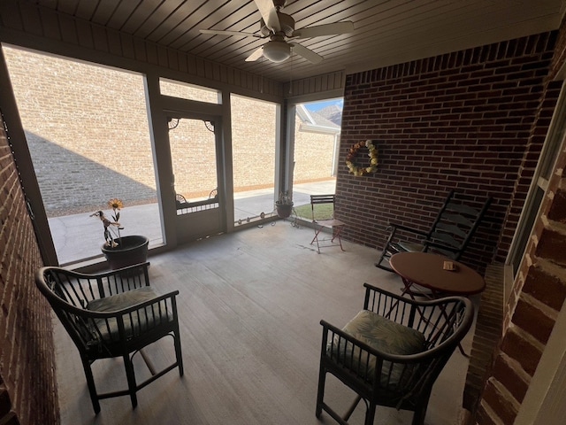 sunroom / solarium with ceiling fan and wooden ceiling