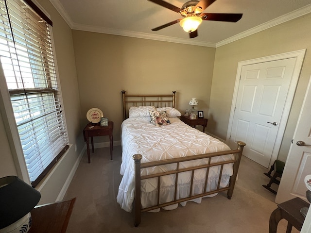 carpeted bedroom with ceiling fan and crown molding