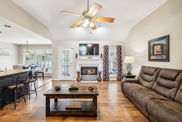 living room featuring vaulted ceiling, hardwood / wood-style flooring, and ceiling fan