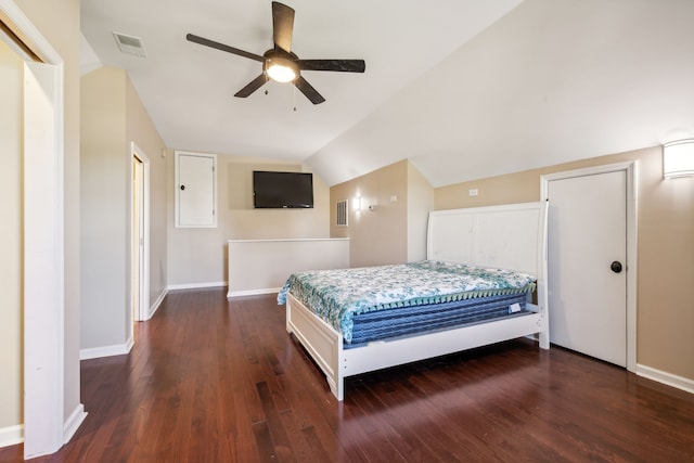 bedroom with ceiling fan, vaulted ceiling, and dark hardwood / wood-style flooring