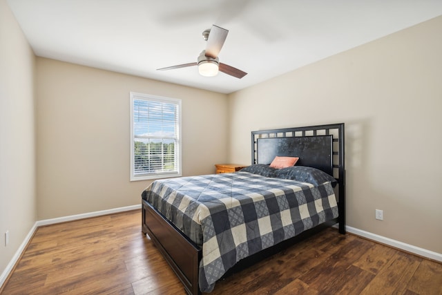 bedroom with ceiling fan and dark wood-type flooring