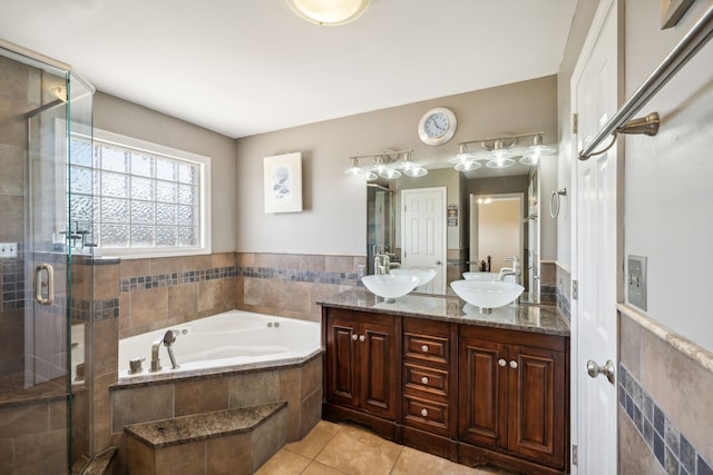 bathroom featuring tile patterned flooring, separate shower and tub, and vanity