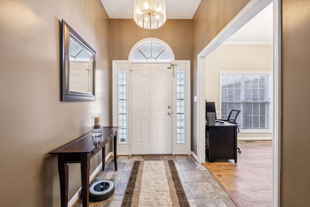 entrance foyer with a notable chandelier, hardwood / wood-style floors, and a wealth of natural light