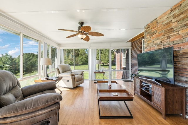 sunroom / solarium featuring ceiling fan