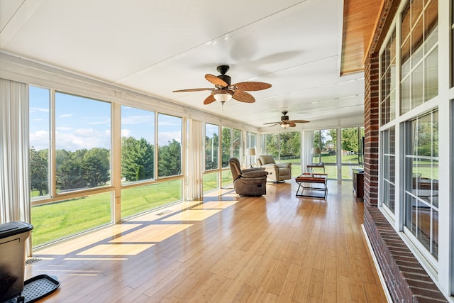 unfurnished sunroom featuring ceiling fan and a wealth of natural light