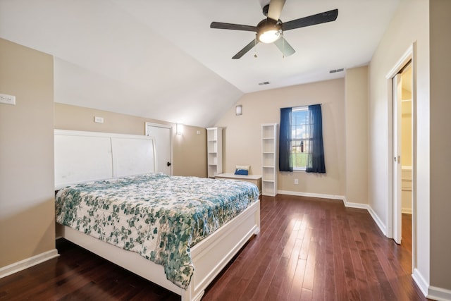 bedroom with dark wood-type flooring, vaulted ceiling, connected bathroom, and ceiling fan