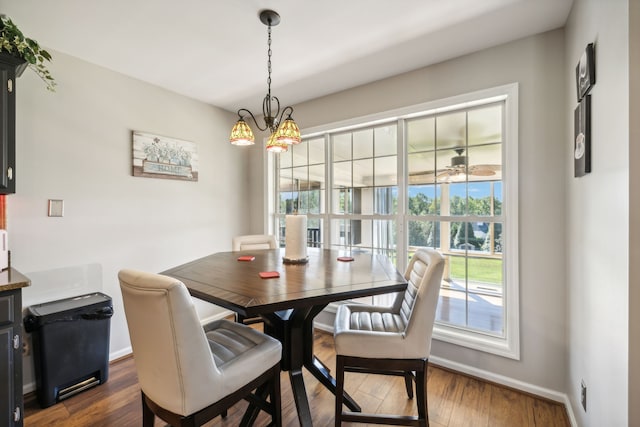 dining area featuring a chandelier and dark hardwood / wood-style flooring