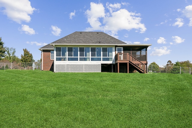 back of property featuring a lawn and a deck