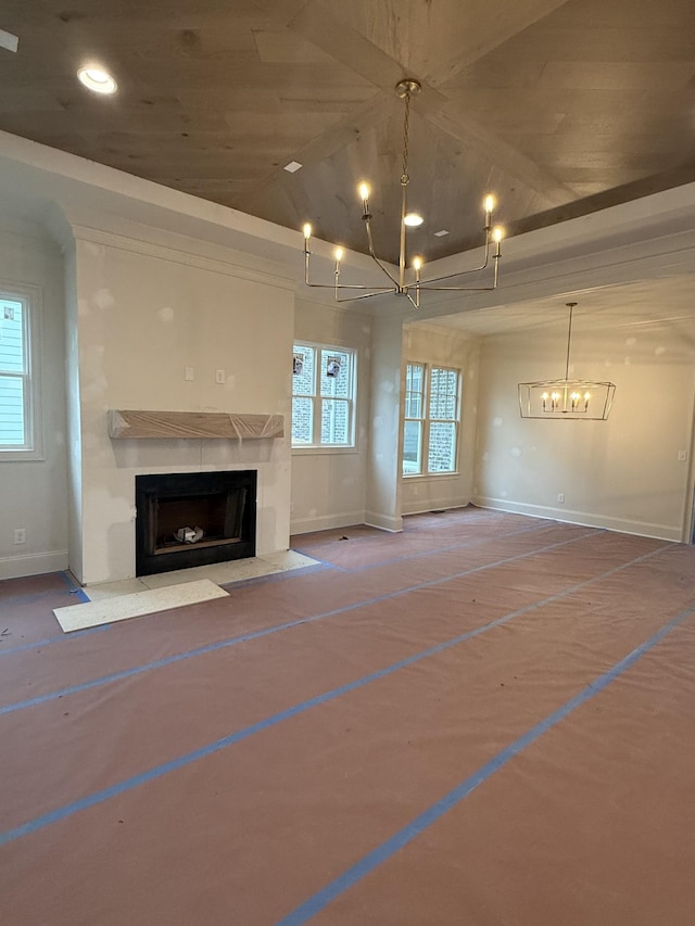 unfurnished living room with an inviting chandelier, a high end fireplace, and lofted ceiling