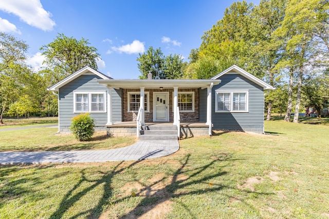 ranch-style home with a porch and a front lawn