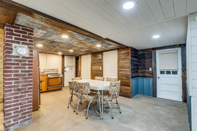 dining room with wooden walls