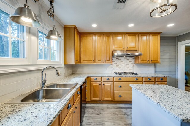 kitchen featuring hanging light fixtures, black dishwasher, light wood-type flooring, an inviting chandelier, and sink