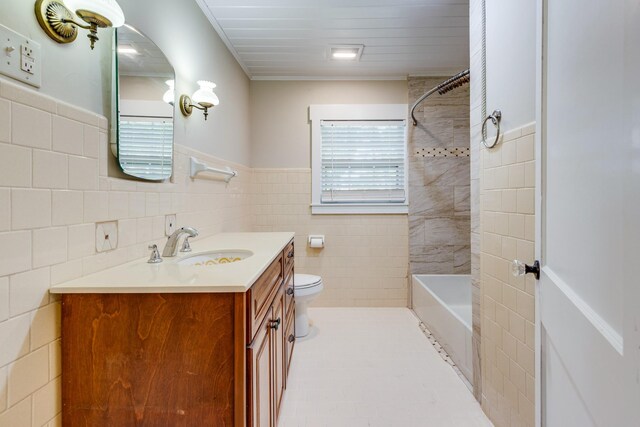 full bathroom featuring tile walls, tile patterned flooring, shower / washtub combination, vanity, and toilet