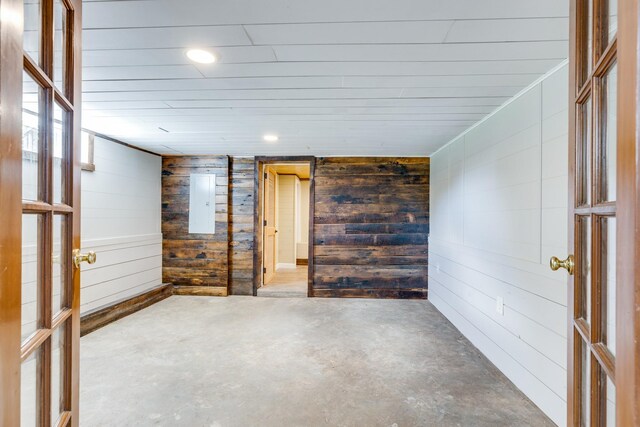 basement featuring wooden walls