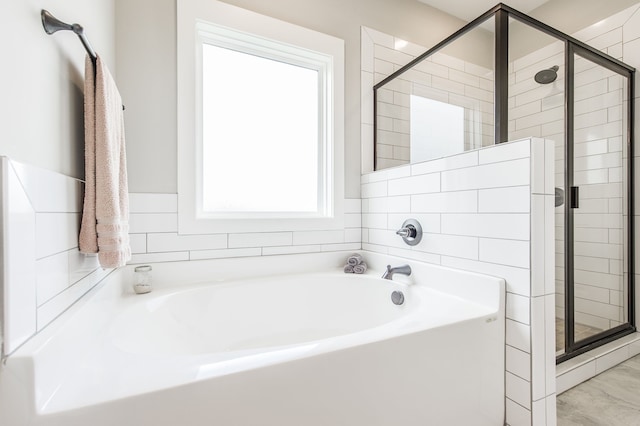 bathroom featuring shower with separate bathtub and a wealth of natural light