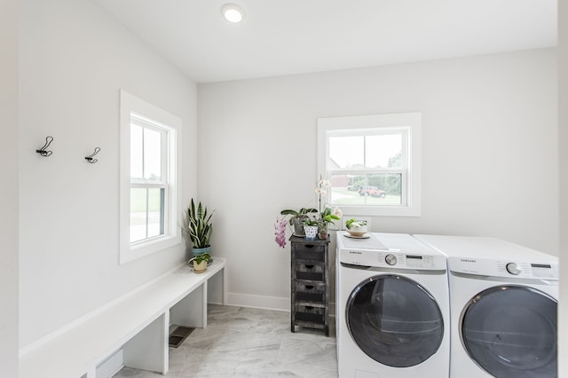 washroom featuring plenty of natural light and separate washer and dryer