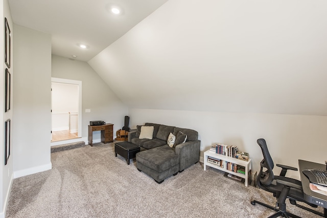 carpeted office featuring vaulted ceiling