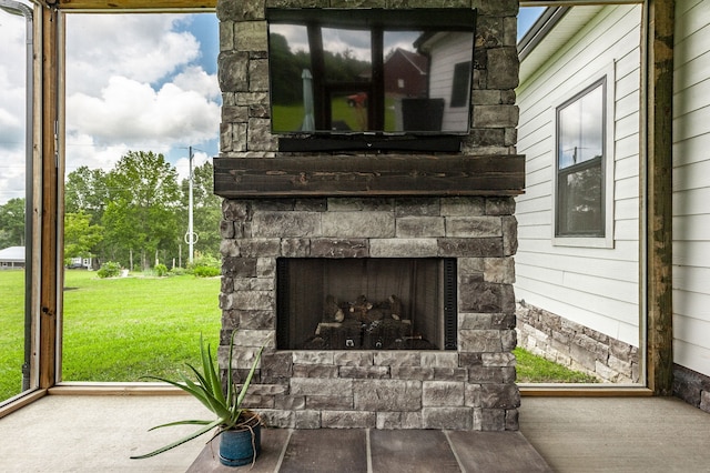 exterior details featuring carpet floors, wood walls, and an outdoor stone fireplace