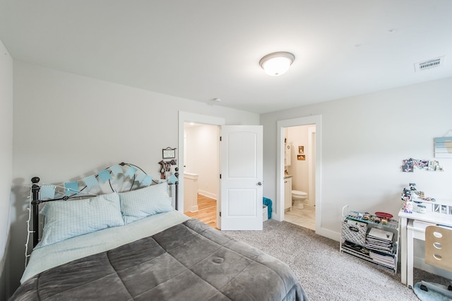 carpeted bedroom with ensuite bath