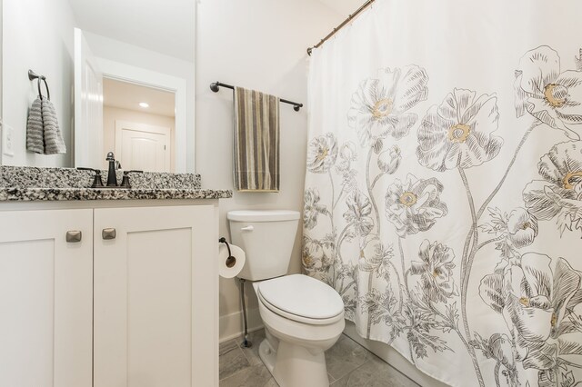 bathroom with curtained shower, tile patterned flooring, vanity, and toilet