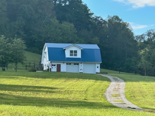 exterior space featuring a garage and a yard