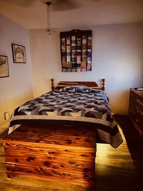 bedroom featuring ceiling fan and wood-type flooring