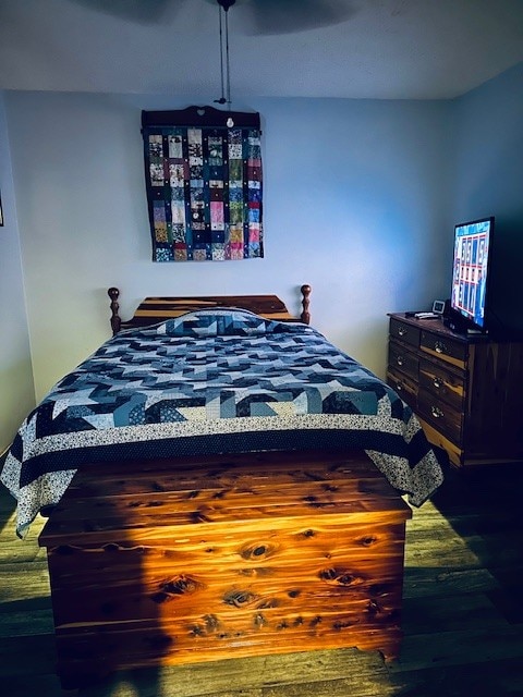 bedroom with hardwood / wood-style floors and ceiling fan