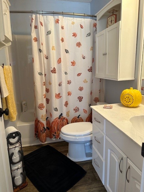 full bathroom featuring shower / bath combination with curtain, vanity, and toilet