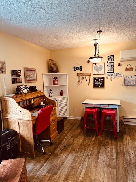 home office featuring dark hardwood / wood-style floors, a wall mounted AC, and a textured ceiling