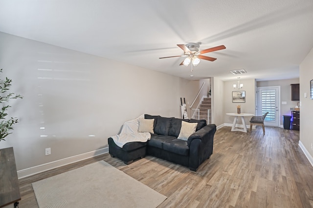 living room with light wood-type flooring and ceiling fan