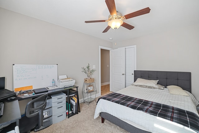 bedroom with ceiling fan and light colored carpet