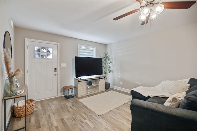 living room featuring ceiling fan and light hardwood / wood-style flooring