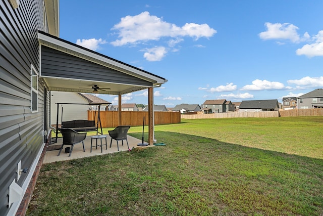 view of yard with ceiling fan and a patio area