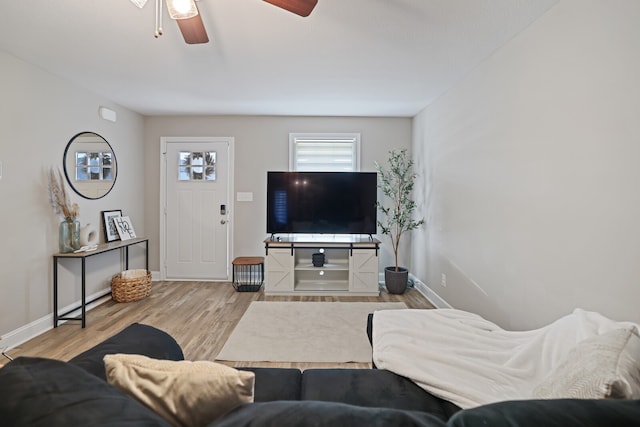 living room featuring light hardwood / wood-style floors and ceiling fan