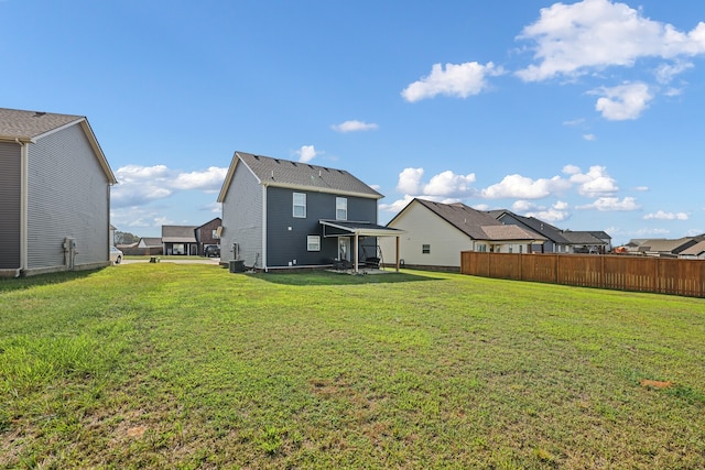 back of house with a patio and a yard