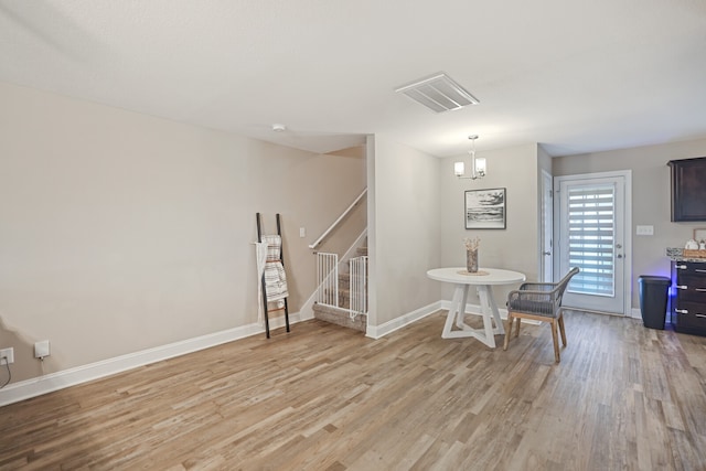 dining area with a notable chandelier and light wood-type flooring