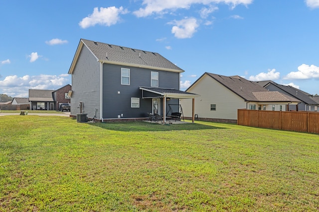 rear view of property featuring a yard and a patio area