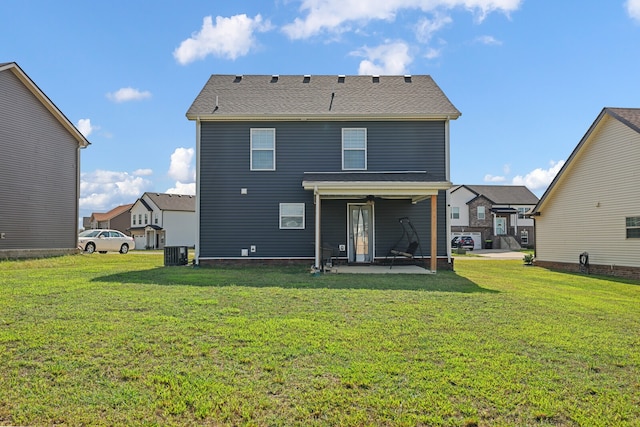 rear view of house with cooling unit, a lawn, and a patio area